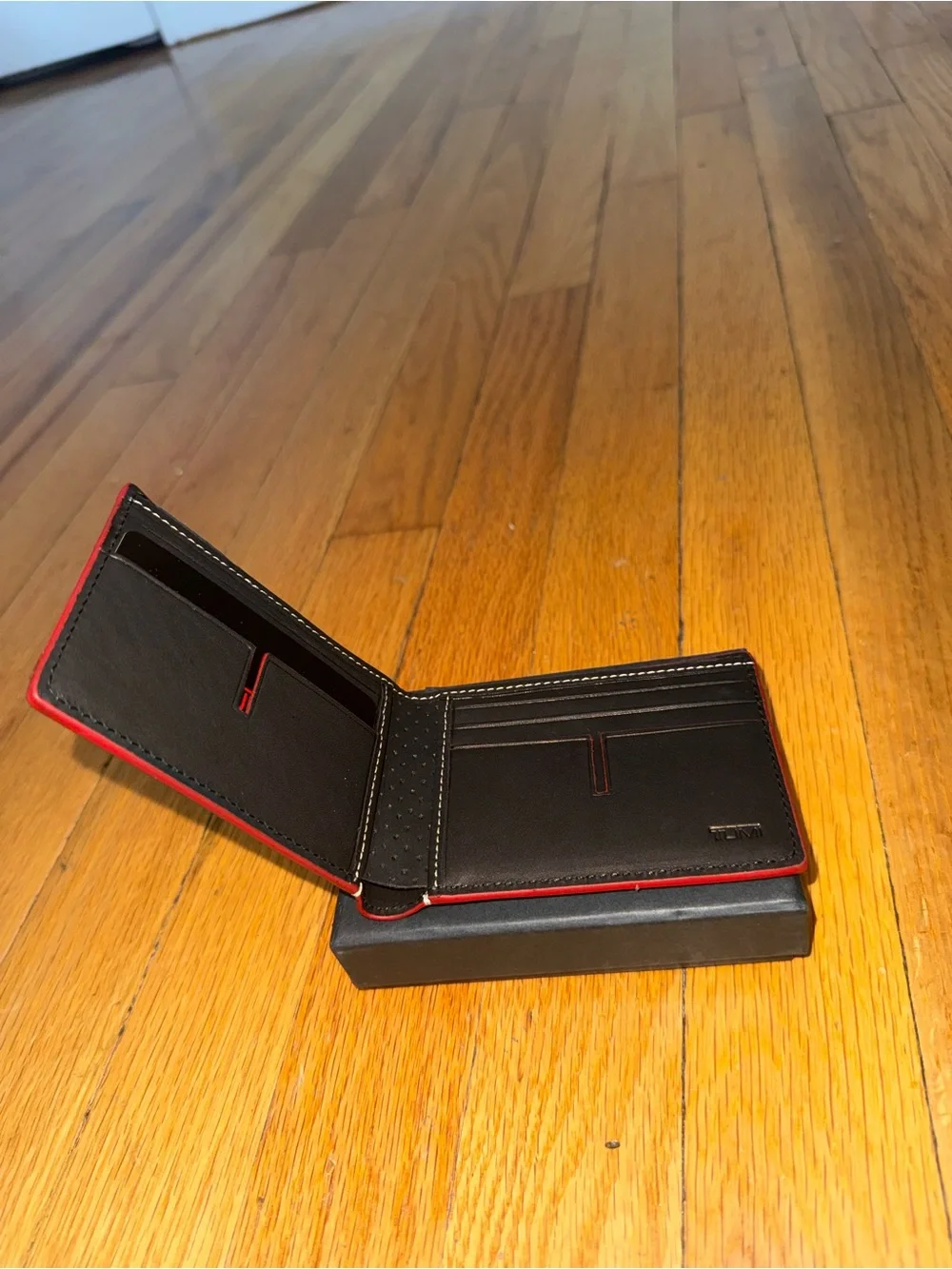 Tumi Black Leather Bifold Wallet with Red Edge